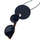 Large Black Polymer Clay Statement necklace holding sunglasses on a white background 