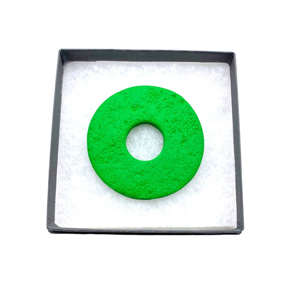 Bright Green polymer clay brooch in a box on a white background