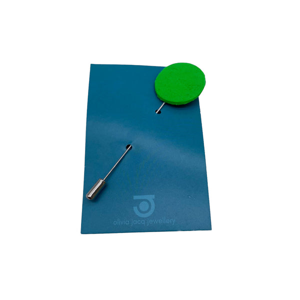 Bright Green Polymer Clay Lapel Pin with stainless steel pin on a card on a white background