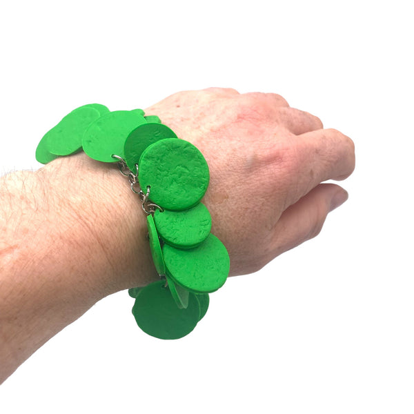 Picture of someone's wrist wearing Bright Green polymer bracelet on a white background 