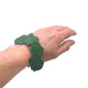 Dark green polymer clay bracelet on someone's wrist