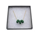 Dark Green polymer clay beads on a gold plated stainless steel chain in a box on a white background