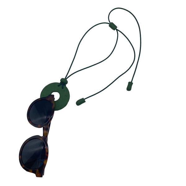 Dark Green Small Circle Necklace with hole holding sunglasses on a white background