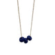 Navy Blue polymer clay beads on a gold plated stainless steel chain on a white background