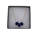 Navy Blue polymer clay beads on a gold plated stainless steel chain in a a box on a white background