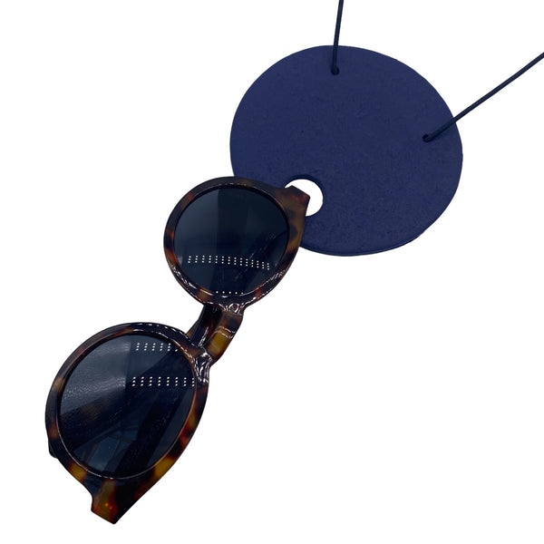 Large Navy Blue Polymer Clay Statement necklace  holding sunglasses on a white background 