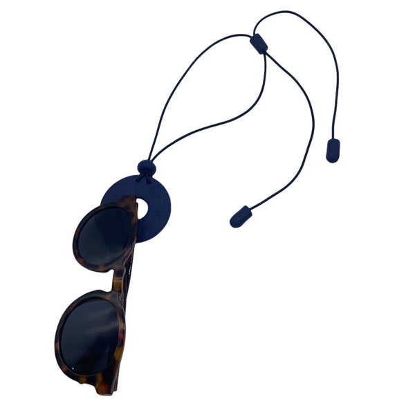 Navy Blue polymer clay statement necklace and glasses holder holding sunglasses on a white background