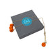 Orange polymer clay beads on a gold plated stainless steel chain on a box on a white background