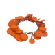 Orange polymer clay bracelet on white background