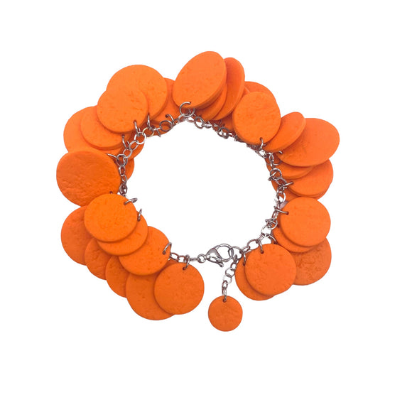 Orange polymer clay bracelet on white background