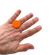 Someone wearing a Orange small polymer clay ring on a white background