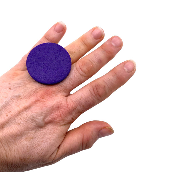 Someone wearing a Purple Large Polymer Clay Ring against a white background