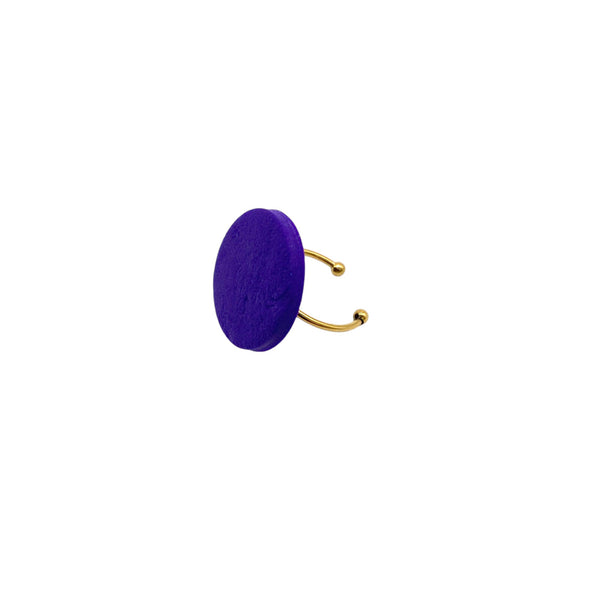 Purple small polymer clay ring on a white background