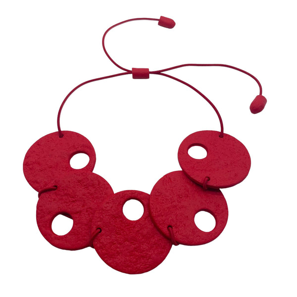 Red polymer clay statement necklace on a white background 