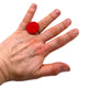 Someone wearing a Red small polymer clay ring on a white background