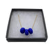 Royal Blue polymer clay beads on a gold plated stainless steel chain on a white background