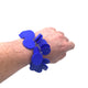 Someone's wrist wearing a Royal Blue polymer clay bracelet on white background