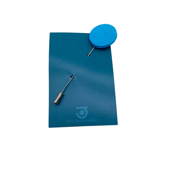 Turquoise Polymer Clay Lapel Pin with stainless steel pin on a card on a white background