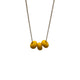 Yellow polymer clay beads on a gold plated stainless steel chain on a white background