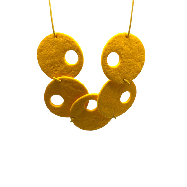 Yellow polymer clay statement necklace on a white background 