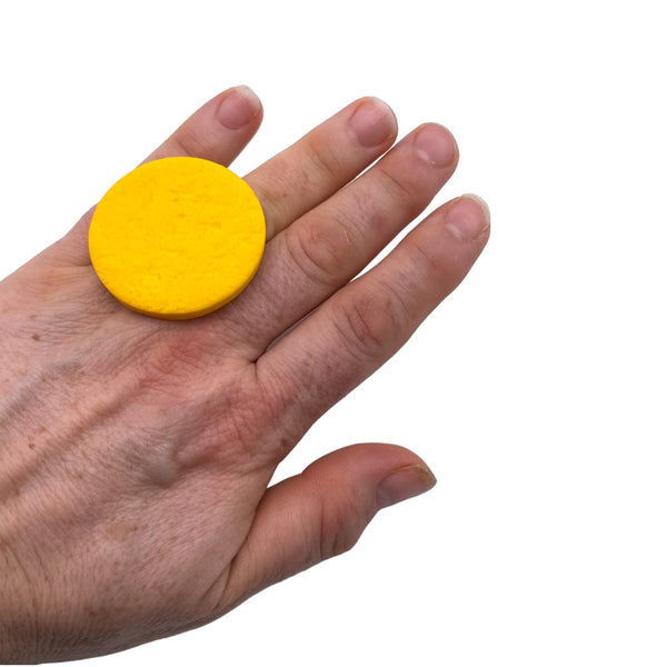 Someone wearing a Yellow Large Polymer Clay Ring against a white background