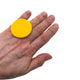 Someone wearing a Yellow Large Polymer Clay Ring against a white background