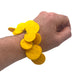 Someone's wrist wearing a Yellow polymer clay bracelet on white background