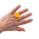 Someone wearing a Yellow small polymer clay ring on a white background