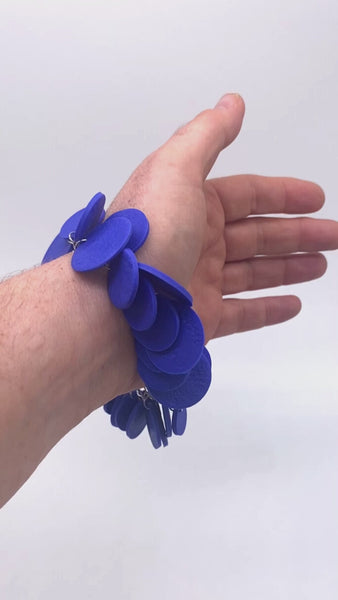 Video of someone wearing a Royal Blue polymer clay bracelet on white background