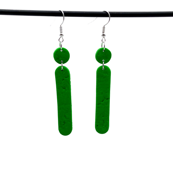 Green Polymer Clay Dangle earrings with shepherd hooks dangling from a dark hanger