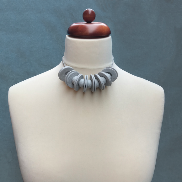 Grey Disc and Bead Polymer Clay statement necklace with coordinating elastic cord on a mannequin to show the various lengths it can be worn