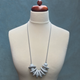 Grey Disc and Bead Polymer Clay statement necklace with coordinating elastic cord on a mannequin to show the various lengths it can be worn