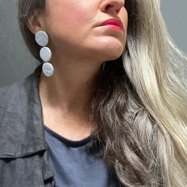 Someone wearing Grey 3 Disc Polymer Clay Statement earrings 