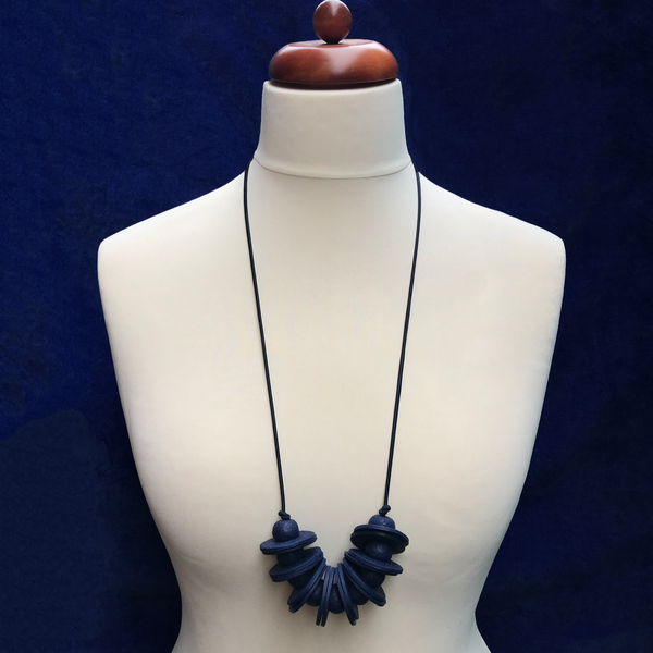 Navy Blue Disc and Bead Polymer Clay statement necklace with coordinating elastic cord on a mannequin to show the various lengths it can be worn