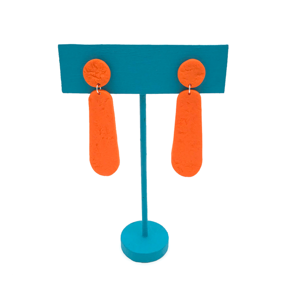 Orange Polymer Clay Dangle Earrings on turquoise stand