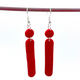 Red Polymer Clay Dangle earrings with shepherd hooks dangling from a red hanger