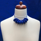 Royal Blue Disc and Bead Polymer Clay statement necklace with coordinating elastic cord on a mannequin to show the various lengths it can be worn