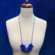 Royal Blue Disc and Bead Polymer Clay statement necklace with coordinating elastic cord on a mannequin to show the various lengths it can be worn