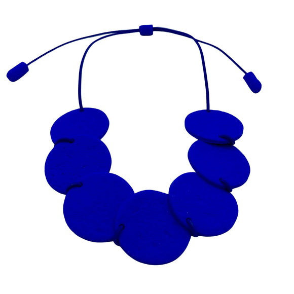 Royal blue polymer clay statement necklace with overlapping discs on an elastic cord