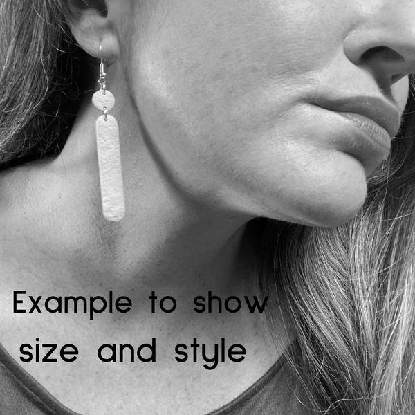 Someone wearing Polymer Clay Dangle earrings with shepherd hooks.  Image is in black and white to show size and colour. 